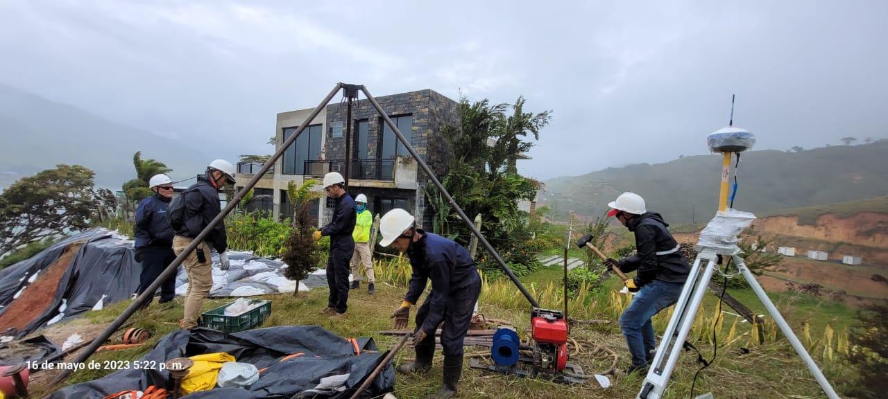 Equipo técnico realizando trabajo de campo geotécnico en una ladera.